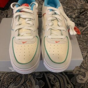 White and Blue Sneakers with Red Accents